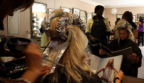The lenghts people will go to suit the 'ideal', such as dying their hair. Chantel Botes (23) is depicted here, having chemicals put into her hair by hairdresser Marilise Verhoef.People like Chantel often model their ideal image on those that are depicted in magazines, such as the one Chantel is looking through.